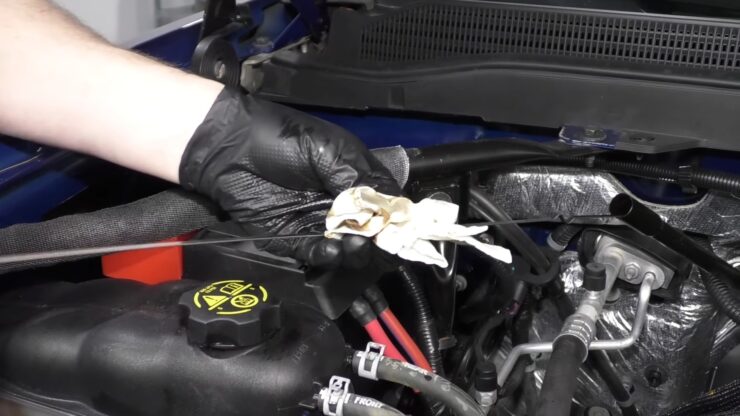 How to Check and Fill Transmission Fluid - wipe the dipstick on Chevy Silverado